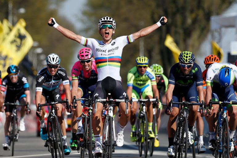 Michal Kwiatkowski celebrates as he crosses the finish line and wins the 50th edition of the Amstel Gold race