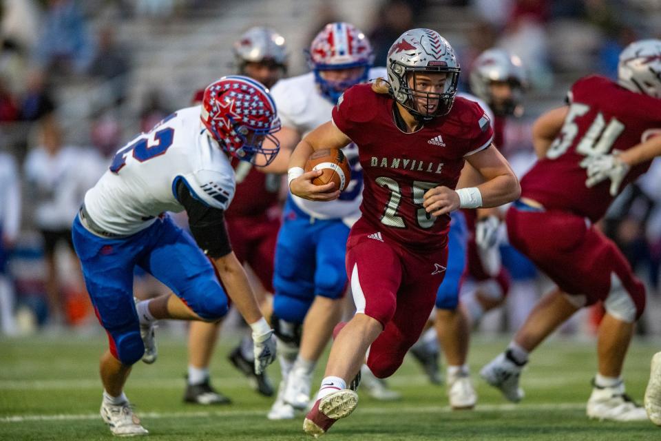 Danville Community High School sophomore Ethan Wooten (25) runs the ball out of the backfiel during the first half of an IHSAA varsity football game against Western Boone High School, Friday, Oct. 6, 2023, at Danville Community High School.