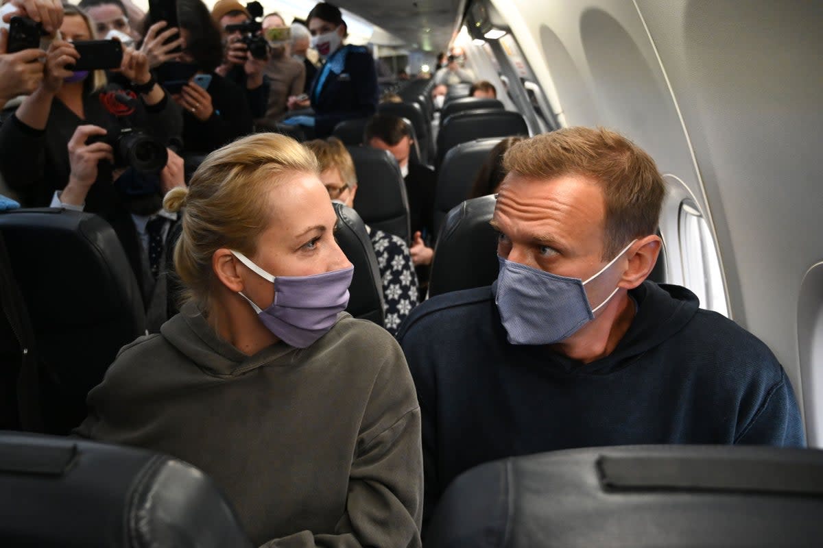 Navalny and his wife Yulia leaving Germany in 2021 (AFP via Getty)