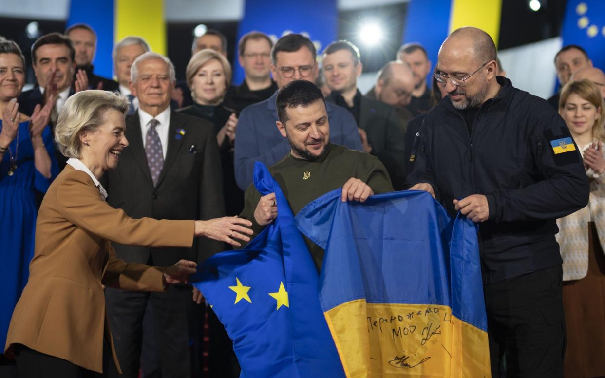 Volodymyr Zelensky and Ursula von der Leyen hold Ukrainian and European Union flags after meeting in Kyiv on Thursday. However, EU membership could still be some time away for Kyiv - Ukrainian Presidency/Anadolu Agency via Getty Images