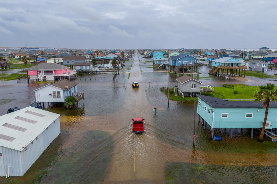 SURFSIDE BEACH, TEXAS - JUNE 19: In this aerial image, vehicles drive through flooded neighborhoods on June 19, 2024 in Surfside Beach, Texas. Storm Alberto, the first named tropical storm of the hurricane season, was located approximately 305 miles south-southeast of Brownsville, Texas and formed earlier today in the Southwestern Gulf of Mexico. The storm has produced heavy winds and rainfall, creating flooding within various communities along Texas coastlines.  (Photo by Brandon Bell/Getty Images)