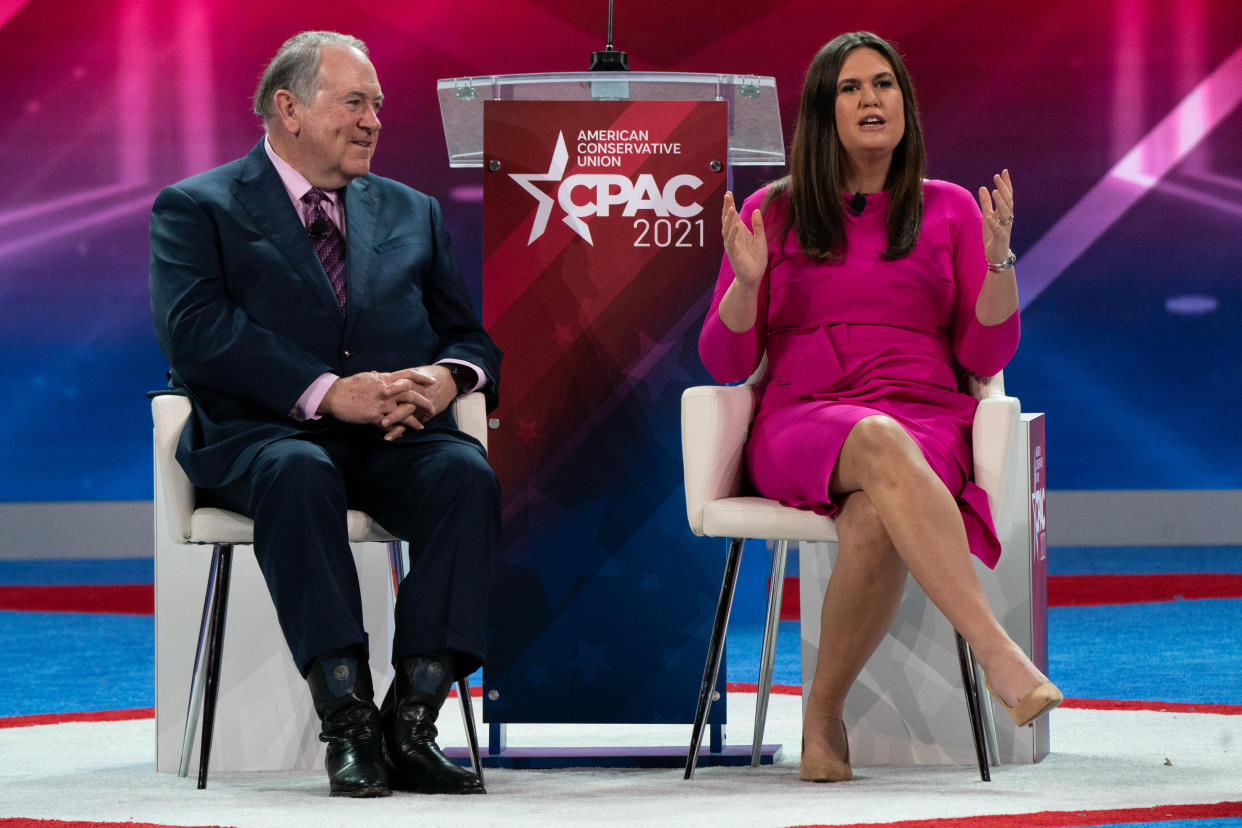 Former Arkansas Gov. Mike Huckabee with his daughter, Sarah Huckabee Sanders, onstage at the Conservative Political Action Conference in Orlando.