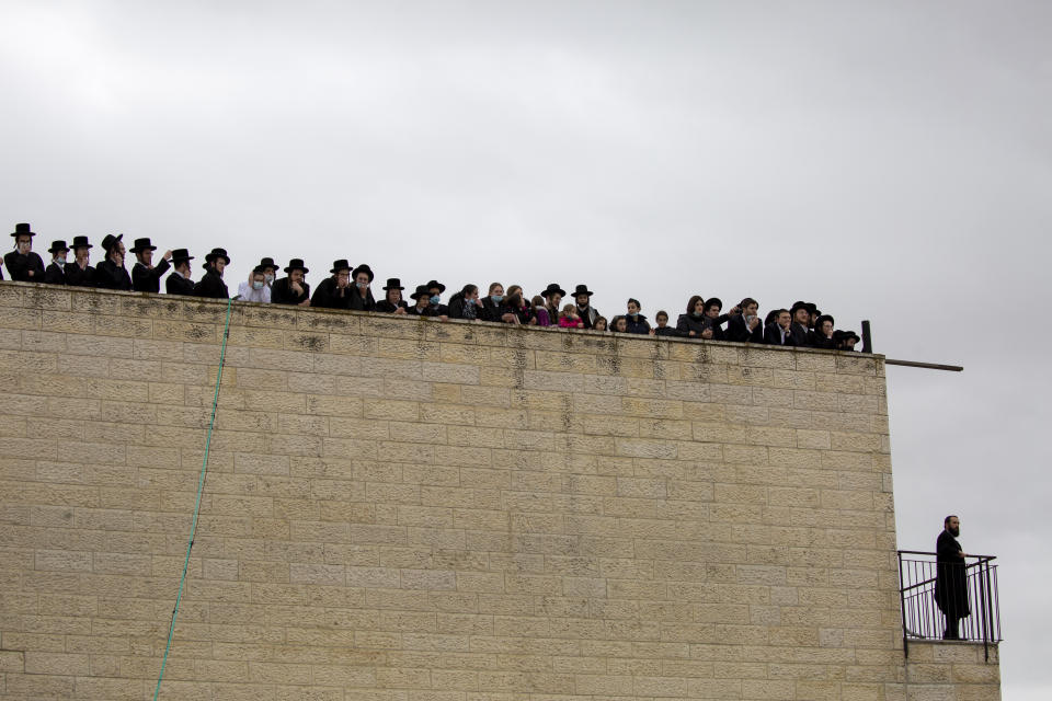 Ultra-Orthodox Jews participate in funeral for prominent rabbi Meshulam Soloveitchik, in Jerusalem, Sunday, Jan. 31, 2021. The mass ceremony took place despite the country's health regulations banning large public gatherings, during a nationwide lockdown to curb the spread of the coronavirus. (AP Photo/Ariel Schalit)