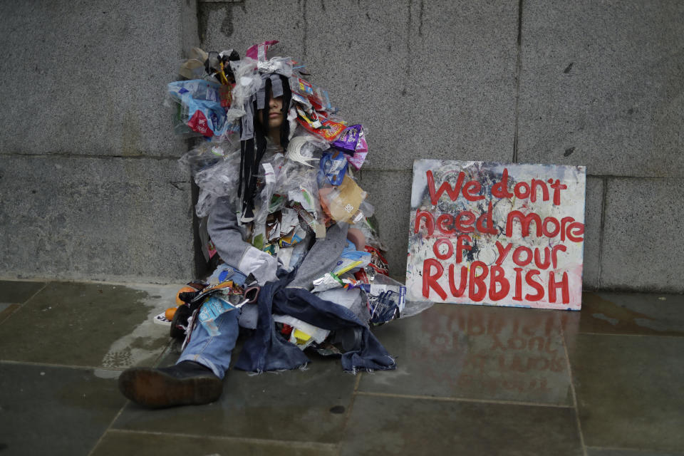 A climate protestors sits outside Britain's Parliament in central London Monday, Oct. 7, 2019. Extinction Rebellion movement blocked major roads in London, Berlin and Amsterdam on Monday at the beginning of what was billed as a wide-ranging series of protests demanding new climate policies. (AP Photo/Matt Dunham)