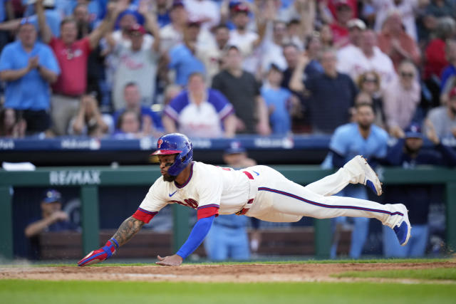 Philadelphia Phillies' Edmundo Sosa dives to score the game-winning run on a fielder's choice by Bryce Harper during the 10th inning of a baseball game against the Toronto Blue Jays, Wednesday, May 10, 2023, in Philadelphia. (AP Photo/Matt Slocum)