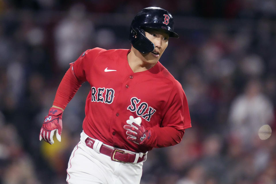 Boston Red Sox's Masataka Yoshida heads down the first base line on his single during the sixth inning of a baseball game against the Cincinnati Reds at Fenway Park, Tuesday, May 30, 2023, in Boston. (AP Photo/Charles Krupa)