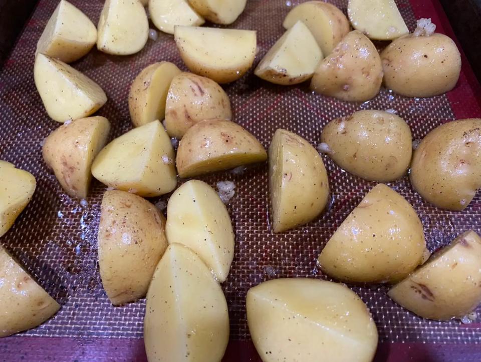 chunks of seasoned potatoes on a sheet pan