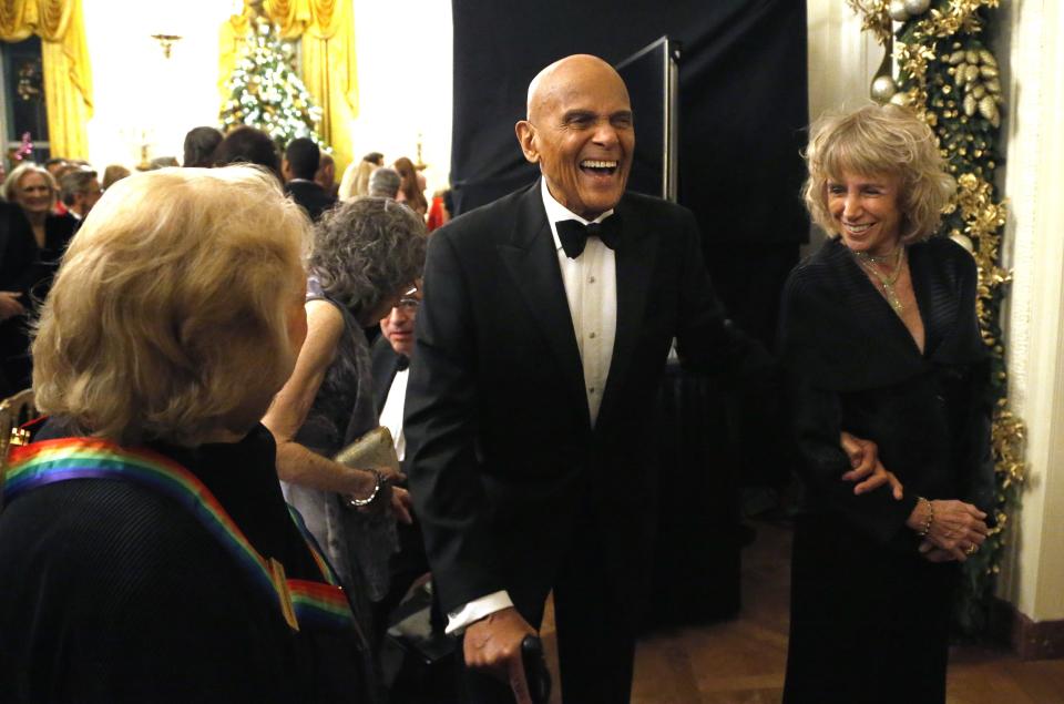 Belafonte laughs with a fellow audience member as they depart after a reception in Washington