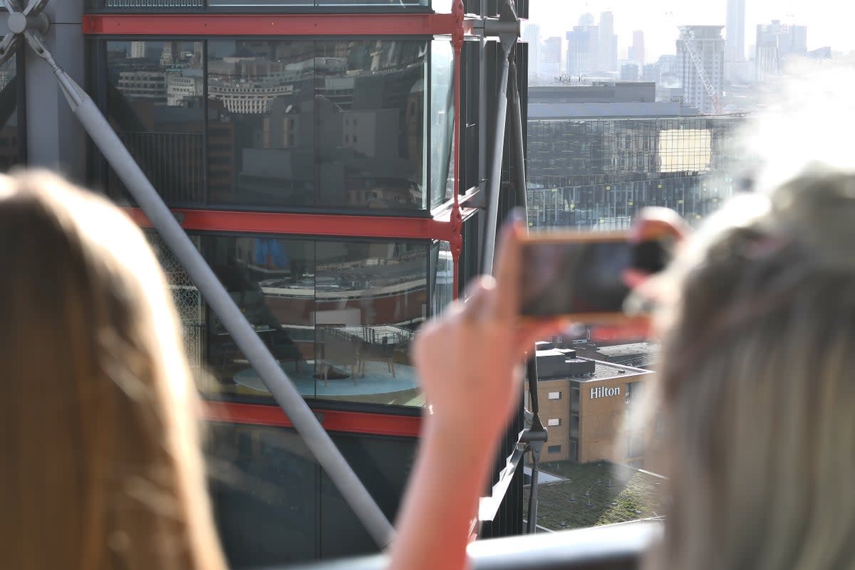 Visitors take snaps from the viewing platform (PA)