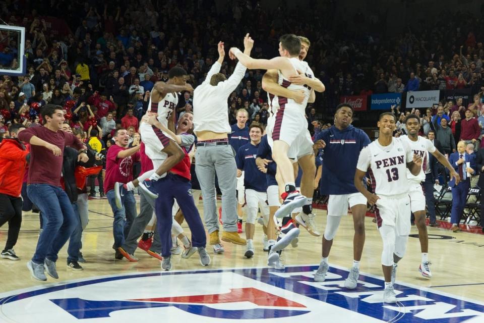 AJ Brodeur #25, Max Rothschild #0, and Eddie Scott #13 of the Pennsylvania Quakers celebrate a 78-75 win against the Villanova Wildcats on Dec. 11, 2018 at The Palestra in Philadelphia. (Photo by Mitchell Leff/Getty Images)