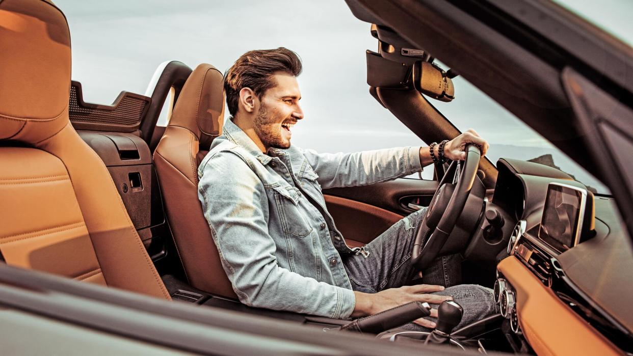 young man driving a luxury car