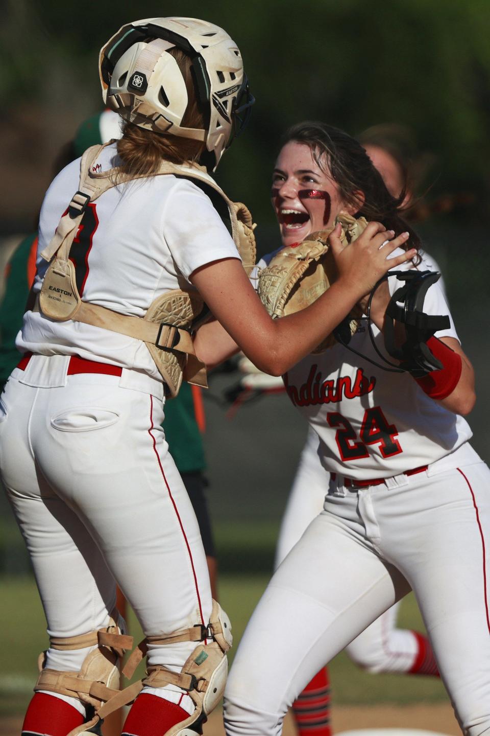 Baldwin pitcher Piper Young (24) and catcher Cali Hartung (9) celebrate a strikeout against Mandarin in Friday night's Gateway Conference softball final.