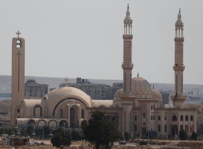 A car drives in front of "El Aziem" (Mosque of The Great) and St. Antony Church in Cairo suburb of Maadi