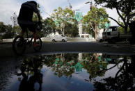 A man cycles past a construction site where locally transmitted Zika cases were first discovered in Singapore August 31, 2016. REUTERS/Edgar Su