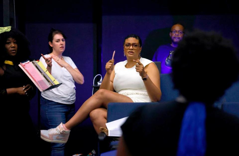 Tina Kelly, center, directs Ashleigh Gilliam, back to camera, during a rehearsal for “The Glorious World of Crowns, Kinks and Curls” at The Arts Factory on May 4.