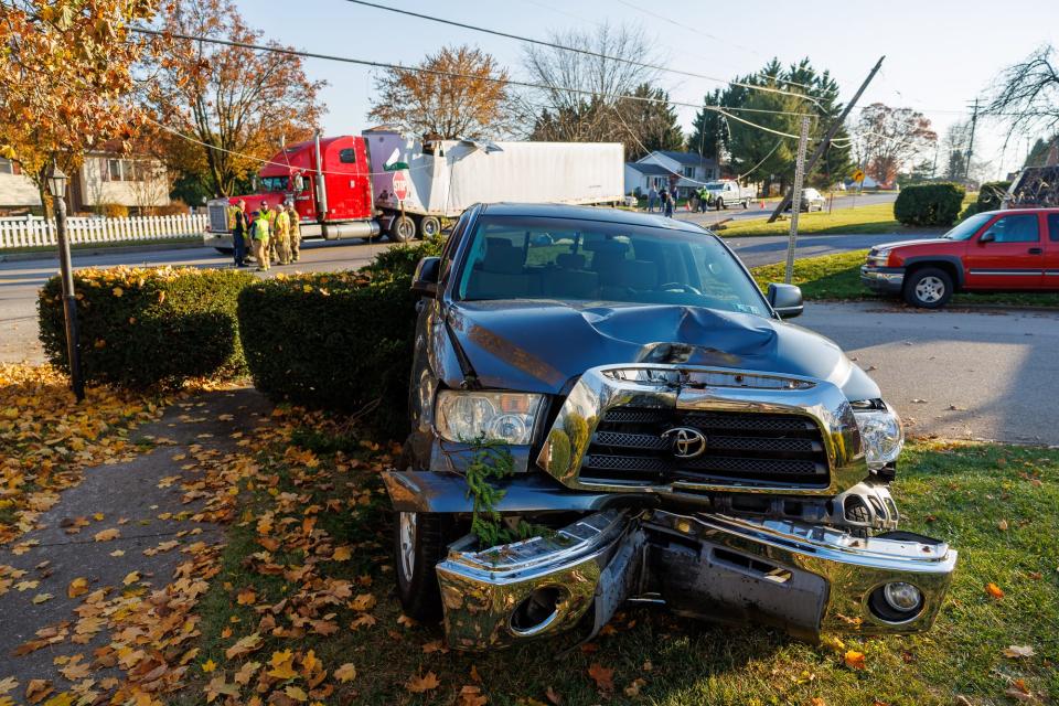 A pickup truck sits in front of a damage semi-truck and utility poles at the scene of a second crash on the 3000 block of Grandview Road, Monday, Nov. 13, 2023, in Penn Township.