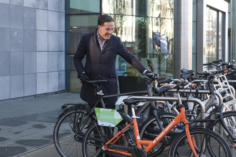 Dutch Prime Minister Mark Rutte parks his bicycle as he arrives to casts his ballot for the provincial elections in The Hague, Netherlands, Wednesday, March 15, 2023. Local elections with national consequences opened Wednesday in the Netherlands as voters cast their ballots for the country's 12 provincial legislatures, which in turn elect the national parliament's upper house. (AP Photo/Mike Corder)