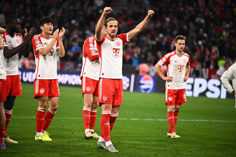 Bayern's Harry Kane (C) celebrates with his teammates following the UEFA Champions League quarter-final second leg soccer match between Bayern Munich and FC Arsenal at Allianz Arena. Tom Weller/dpa