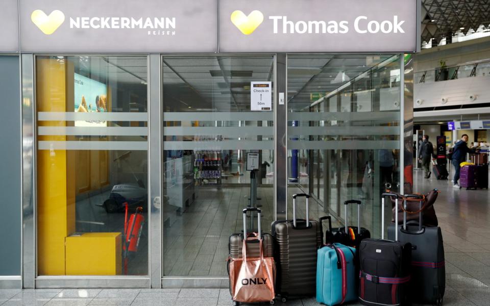 Suitcases are pictured next to a closed Thomas Cook counter at Frankfurt Airport - REUTERS