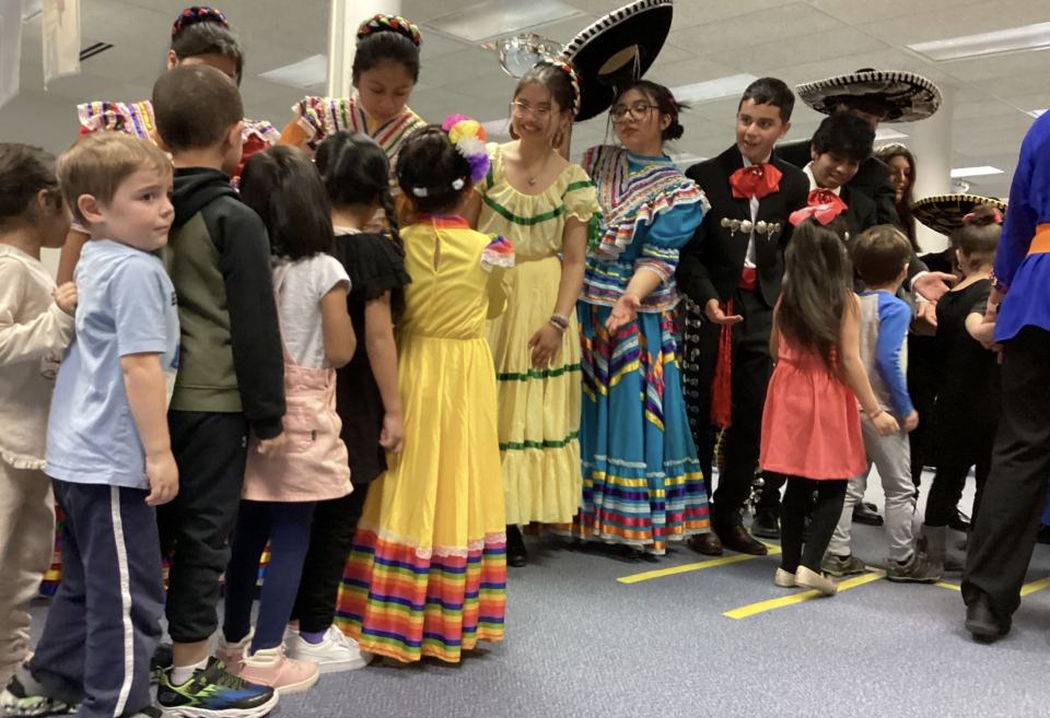 Students and children interact during last year's Family Traditions Day at the Early Learning Center.