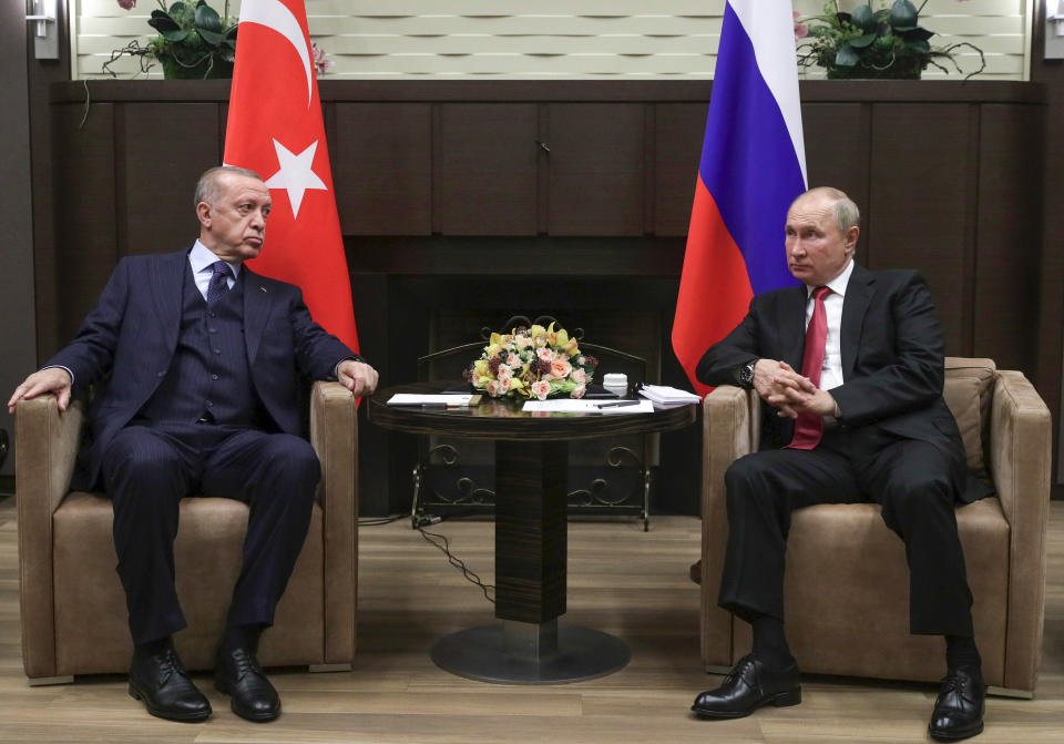 FILE - In this Sept. 29, 2021, file photo, Russian President Vladimir Putin, right, and Turkish President Recep Tayyip Erdogan talk to each other during their meeting in the Bocharov Ruchei residence in the Black Sea resort of Sochi, Russia. In Russia, it's common to get an antibody test for the coronavirus and share the results. Putin referred to his own test results while talking to Erdogan, bragging about how he avoided infection even though dozens of people around him caught the virus, including someone who spent a whole day with him. (Vladimir Smirnov/Sputnik, Kremlin/Pool Photo via AP)