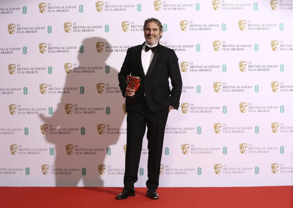 Actor Joaquin Phoenix poses with his award for Best Actor for the film Joker, backstage at the Bafta Film Awards, in central London, Sunday, Feb. 2, 2020. (Photo by Joel C Ryan/Invision/AP)