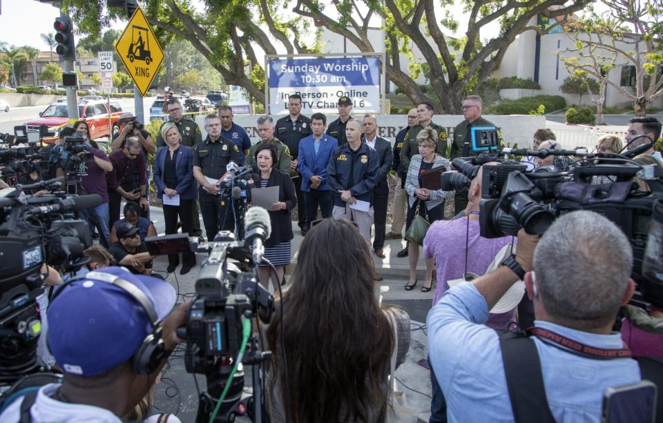 Officials hold a press conference in front of Geneva Presbyterian Church in Laguna Woods