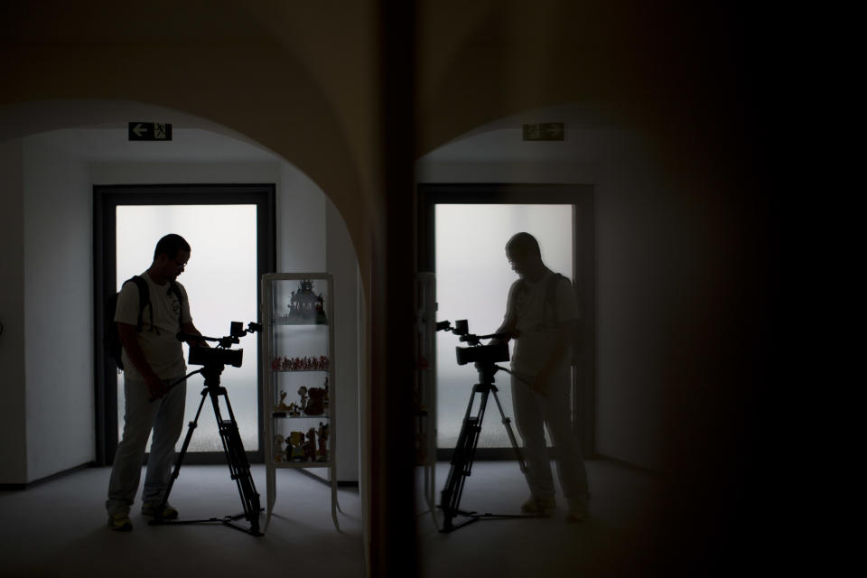 A cameraman records during a media tour at the Casa Daros museum in Rio de Janeiro, Brazil, Wednesday, March 20, 2013. Local officials aiming to transform Rio de Janeiro from a sleepy cultural backwater into an art hotspot are inaugurating this week Casa Daros, a new museum that draws on one of the world's premier collections of contemporary Latin American art. Casa Daros, a 12,000-square meter (129,000-square foot) exhibition space housed in a renovated 1866 mansion, will bring to Rio some of the around 1,200 pieces acquired over the past 13 years by independently wealthy Zurich-based collector Ruth Schmidheiny. (AP Photo/Felipe Dana)