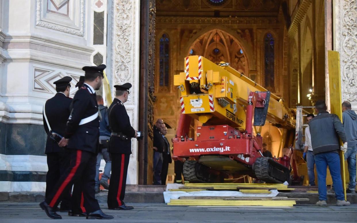 Policemen stand watch as a crane is brought to the scene at the Santa Croce Basilica - ANSA