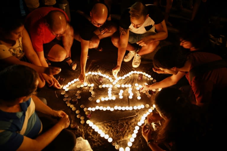 People light candles during a gathering in downtown Jerusalem on August 2, 2015 to mourn the death of Shira Banki who was stabbed at the Jerusalem Gay Pride march