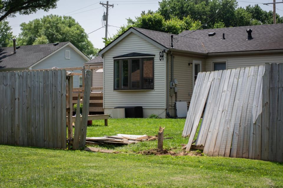 The broken fence in the 2000 block of Camaro Court in Henderson, Kentucky, where police said two escaped Ohio inmates crashed a stolen Mercury Capri during a police chase Wednesday, May 24, 2023.