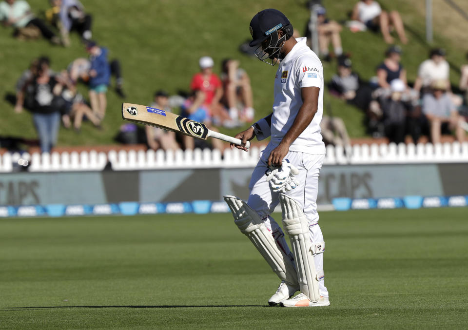 Sri Lanka's Dimuth Karunaratne walks from the field after he was dismissed during play on day three of the first cricket test between New Zealand and Sri Lanka in Wellington, New Zealand, Monday, Dec. 17, 2018. (AP Photo/Mark Baker)