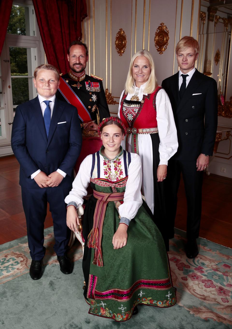 Family photo time! Princess Ingrid Alexandra is surrounded by younger brother Prince Sverre Magnus, father Crown Prince Haakon, mother Crown Princess Mette-Marit and half-brother Marius Borg Hoiby.