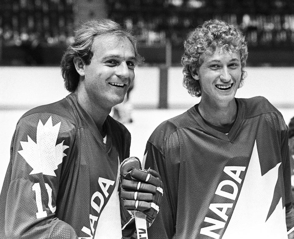 FILE - Montreal Canadiens' Guy Lafleur, left, and Edmonton Oilers' Wayne Gretzky are seen during a break in their light skate at the first day of training camp for Team Canada in Montreal, Aug. 10, 1981. (Ian MacAlpine/The Canadian Press via AP, File)