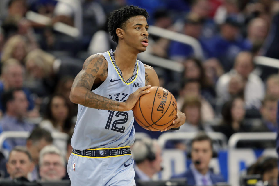 Memphis Grizzlies' Ja Morant (12) passes the ball during the second half of an NBA basketball game against the Orlando Magic, Friday, Nov. 8, 2019, in Orlando, Fla. (AP Photo/John Raoux)