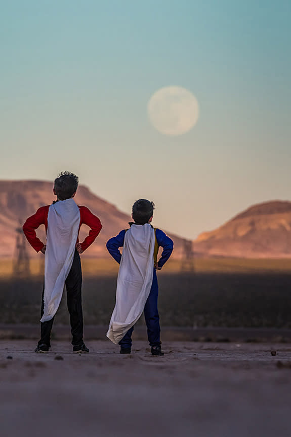 Astrophotographer Tyler S. Leavitt sent in a photo of kids dressed as superheroes watching the supermoon of June 23, 2013, outside Las Vegas, Nevada.