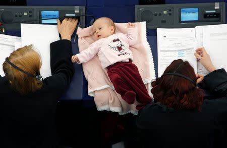 FILE PHOTO: Denmark's member of the European Parliament Hanne Dahl (R) takes part with her baby in a voting session at the European Parliament in Strasbourg March 26, 2009. REUTERS/Vincent Kessler/File Photo
