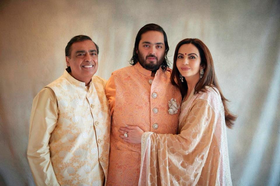 This photograph released by the Reliance group shows from L to R, billionaire industrialist Mukesh Ambani, son Anant and wife Nita, posing for a photograph as guests gather to celebrate Anant's wedding in Jamnagar, India, Saturday, Mar. 02, 2024.