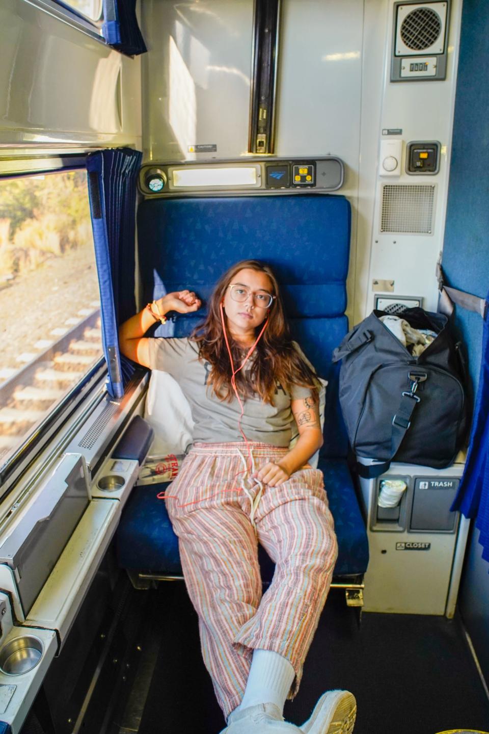 The author sits on the train with her feet up