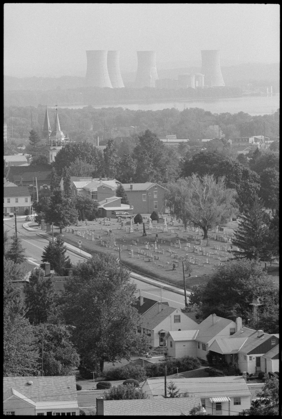 Aerial view, towards Three Mile Island Nuclear Generating Station, as seen across Middletown, Pennsylvania, September 12, 1979. Visible at center is Middleton Cemetery. Earlier in the year, on March 28, 1979, the plant's number two reactor was heavily damaged by the partial nuclear meltdown. (Photo by Thomas J O'Halloran/US News & World Report Magazine Photograph Collection/PhotoQuest/Getty Images)