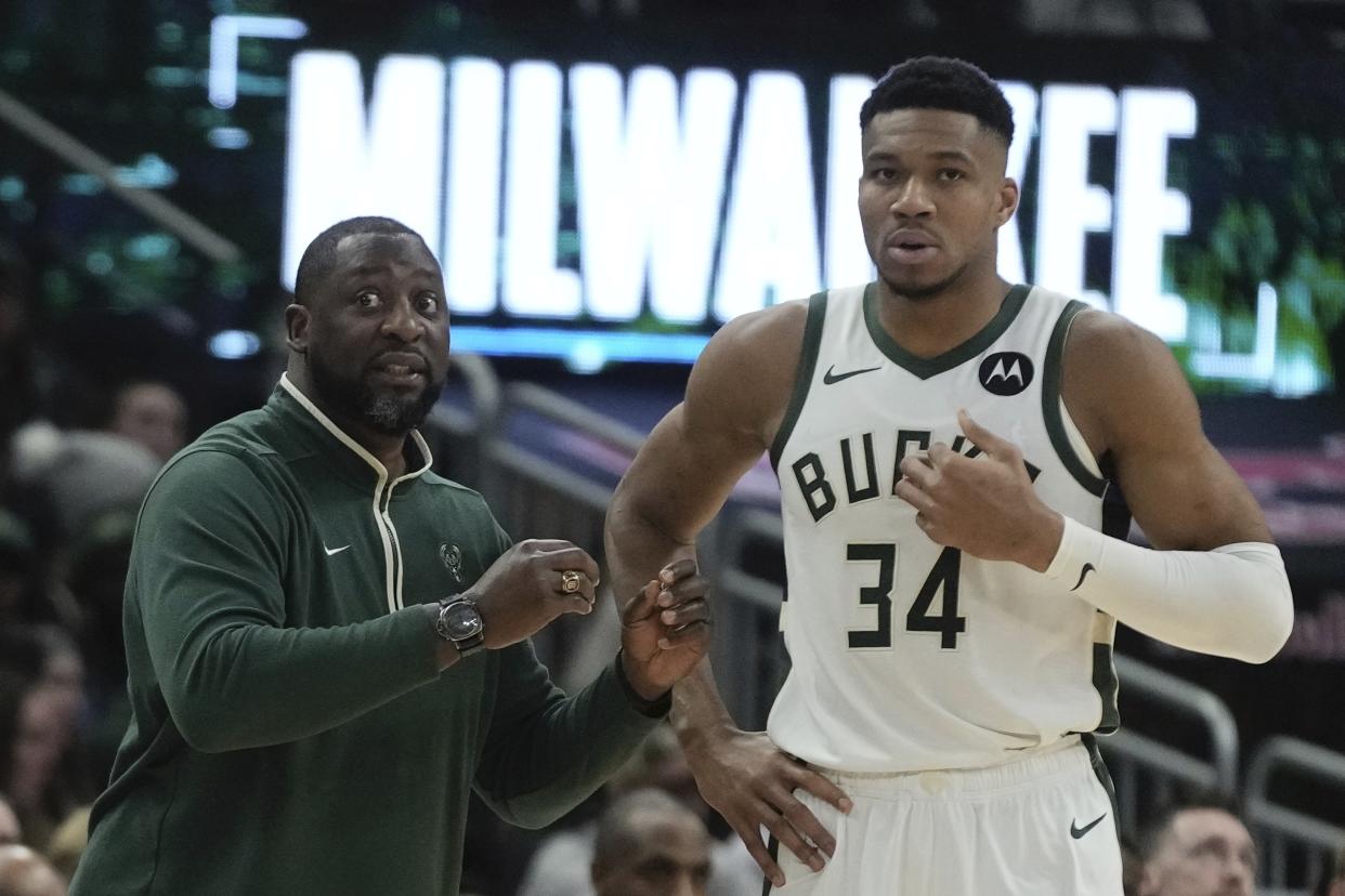 Milwaukee Bucks head coach Adrian Griffin talks to Giannis Antetokounmpo during the first half of an NBA basketball game Wednesday, Dec. 13, 2023, in Milwaukee. (AP Photo/Morry Gash)