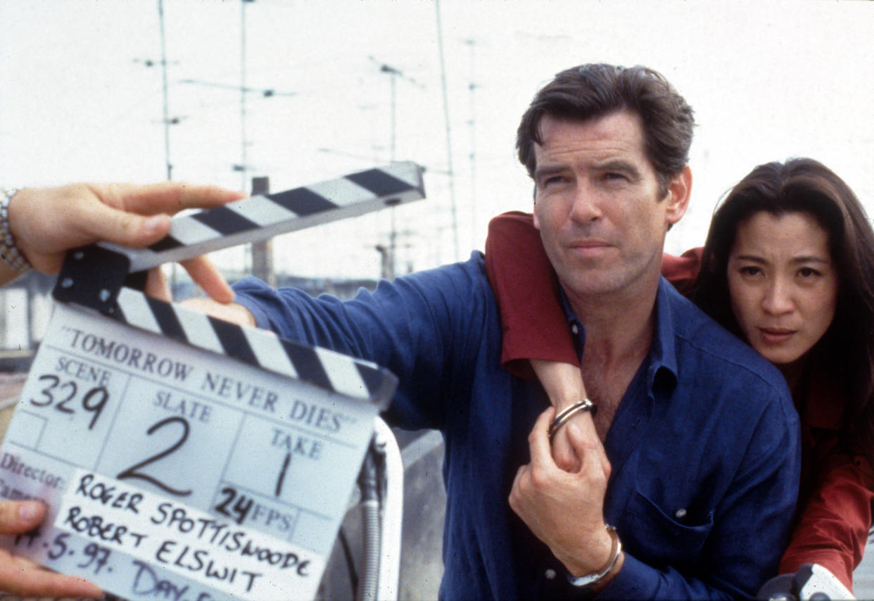 Pierce Brosnan and Michelle Yeoh on location for Tomorrow Never Dies. (Alamy)