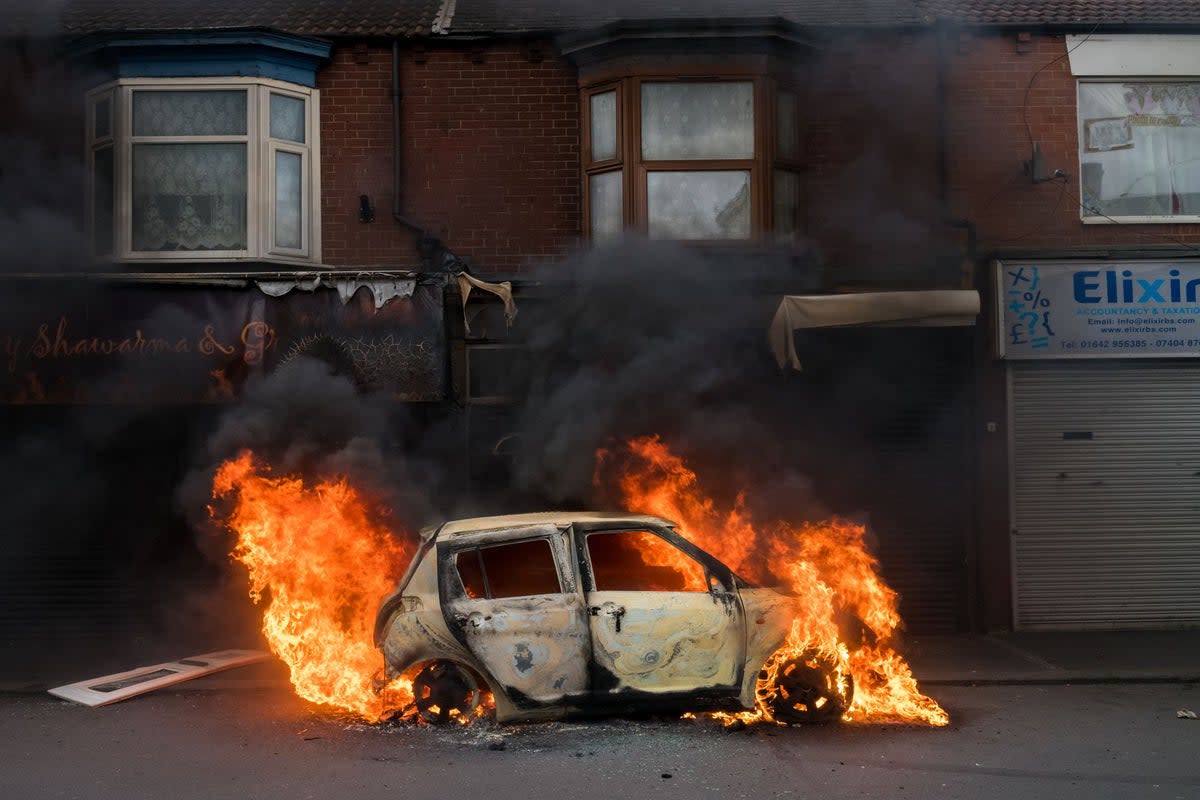 A car burns in Middlesbrough after it was set alight by far-right activists (Getty Images)