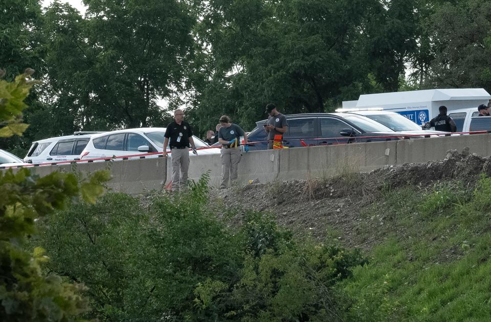 The Ohio Bureau of Criminal Investigation and law enforcement officers on the scene Thursday of a shootout on I-70 east above West Mound Street following the armed robbery of a Porsche SUV from a Whitehall dealership that was later used in a bank robbery on Columbus' Far West Side and led police on a chase that ended on the interstate. One of the three suspects was fatally shot by police. A Columbus police officer was critically wounded. One of two suspects who fled on foot is in custody, police say, and the other was at-large Friday night.