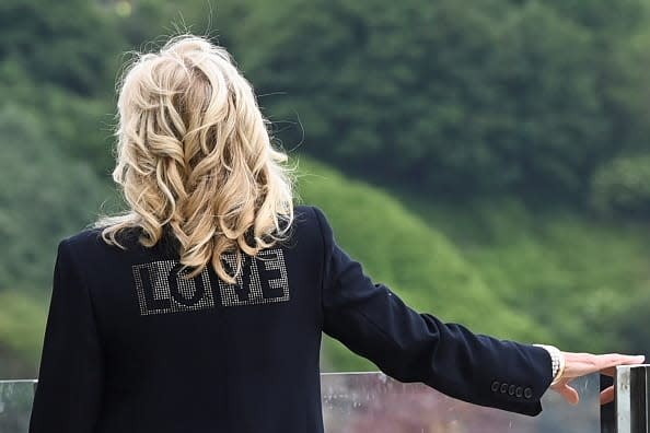 <div class="inline-image__caption"><p>First Lady Jill Biden, wearing a jacket with the phrase "Love" on the back, stands outside the Carbis Bay Hotel on June 10, 2021 in St Ives, England.</p></div> <div class="inline-image__credit">Toby Melville-WPA Pool/Getty Images</div>