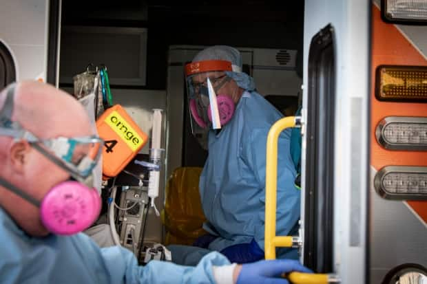 Paramedics with Ornge ambulance service load a patient outside Scarborough General Hospital in April. Ornge reports that as of May 12, it and local paramedic services have been ordered to move 2,134 patients since the start of 2021. (Evan Mitsui/CBC - image credit)