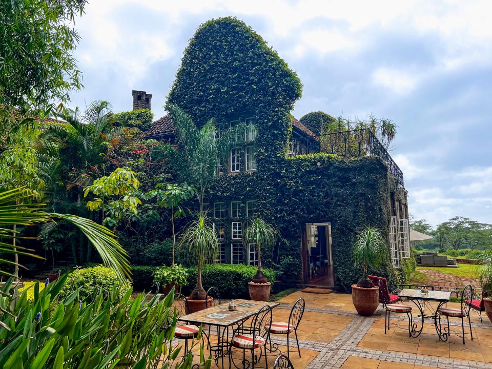 Girafee manor covered in vines and ivy 