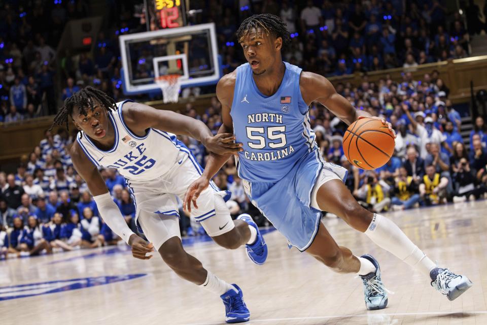 North Carolina's Harrison Ingram (55) handles the ball as Duke's Mark Mitchell (25) defends during the first half of an NCAA college basketball game in Durham, N.C., Saturday, March. 9, 2024. (AP Photo/Ben McKeown)