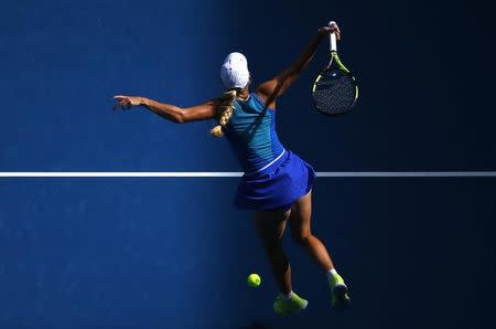 Tennis - Australian Open - Melbourne Park, Melbourne, Australia - 17/1/17 Denmark's Caroline Wozniacki hits a shot behind her back as she jumps during her Women's singles first round match against Australia's Arina Rodionova. REUTERS/Edgar Su