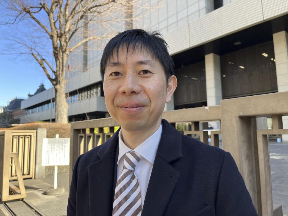 Lawyer Motoki Taniguchi speaks in front of the Tokyo Disctict Court Monday, Jan. 29, 2024. He is among the legal team that is representing plaintiffs filing a lawsuit demanding a stop to “racial profiling.”(AP Photo/Yuri Kageyama)